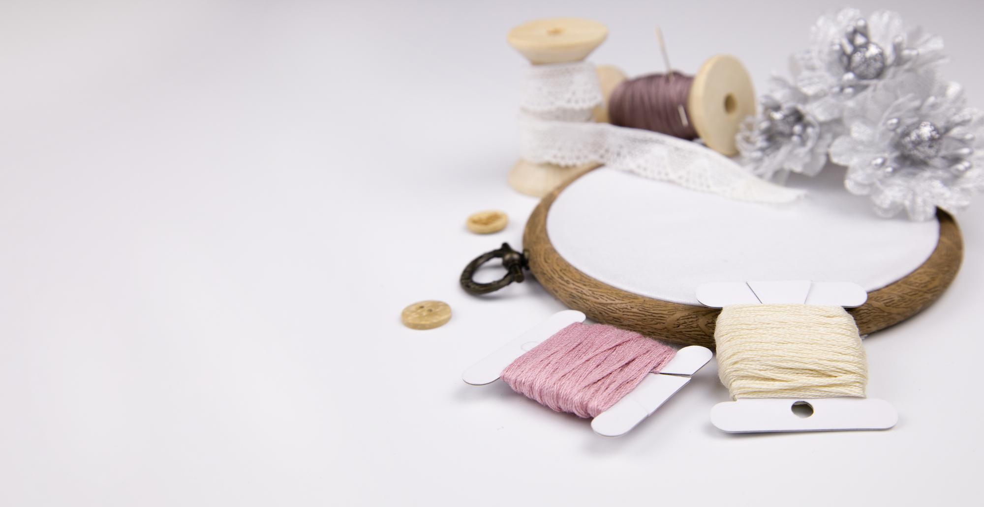 Studio table with hoops, threads and laptop