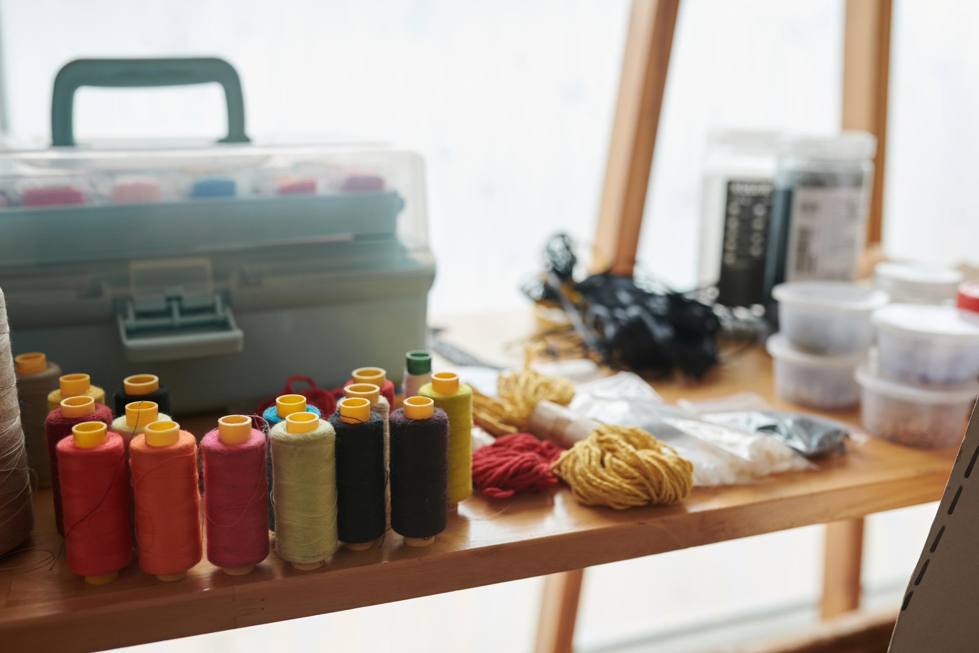 Tools and threads aligned on a workbench